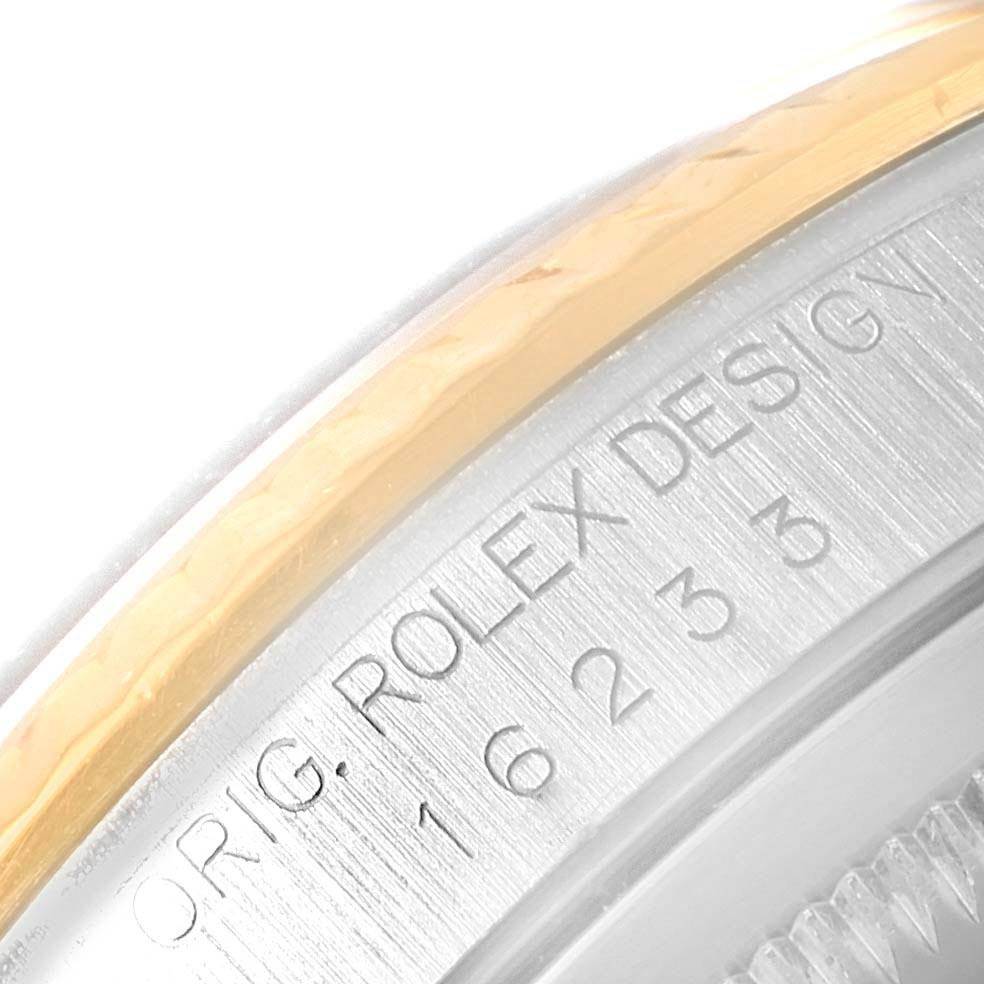 This close-up image of a Rolex Datejust 16233 Men's Steel and Gold (two tone) Blue Dial 16233 Men's Steel and Gold (two tone) Blue Dial watch highlights the engraved text and model number on the side of the casing.