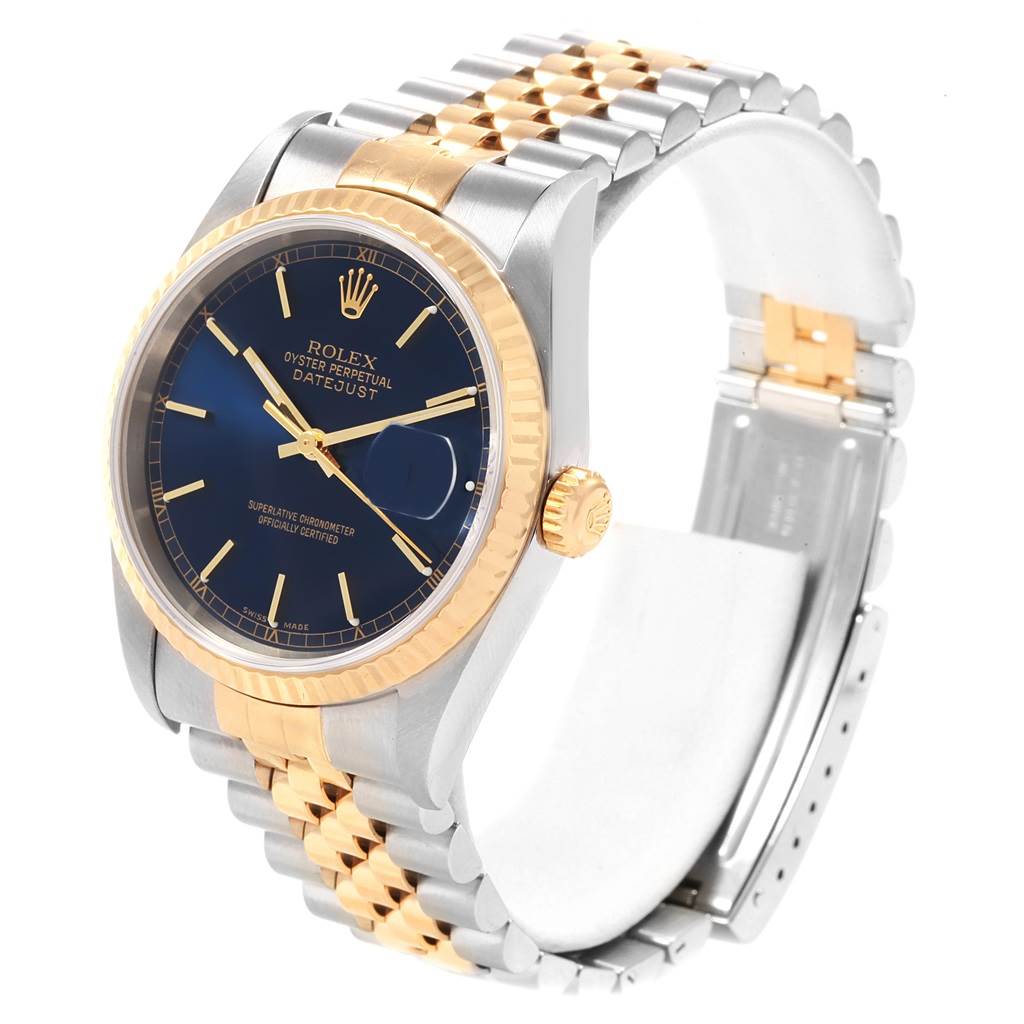 The image shows a Rolex Datejust 16233 Men's Steel and Gold (two tone) Blue Dial 16233 Men's Steel and Gold (two tone) Blue Dial watch at an angled view, highlighting its gold and silver bracelet, bezel, and blue dial.