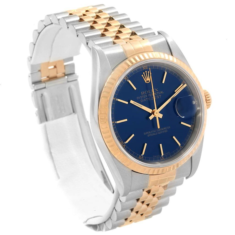 This Rolex Datejust watch is shown at an angled view highlighting its blue dial, gold bezel, and two-tone bracelet.