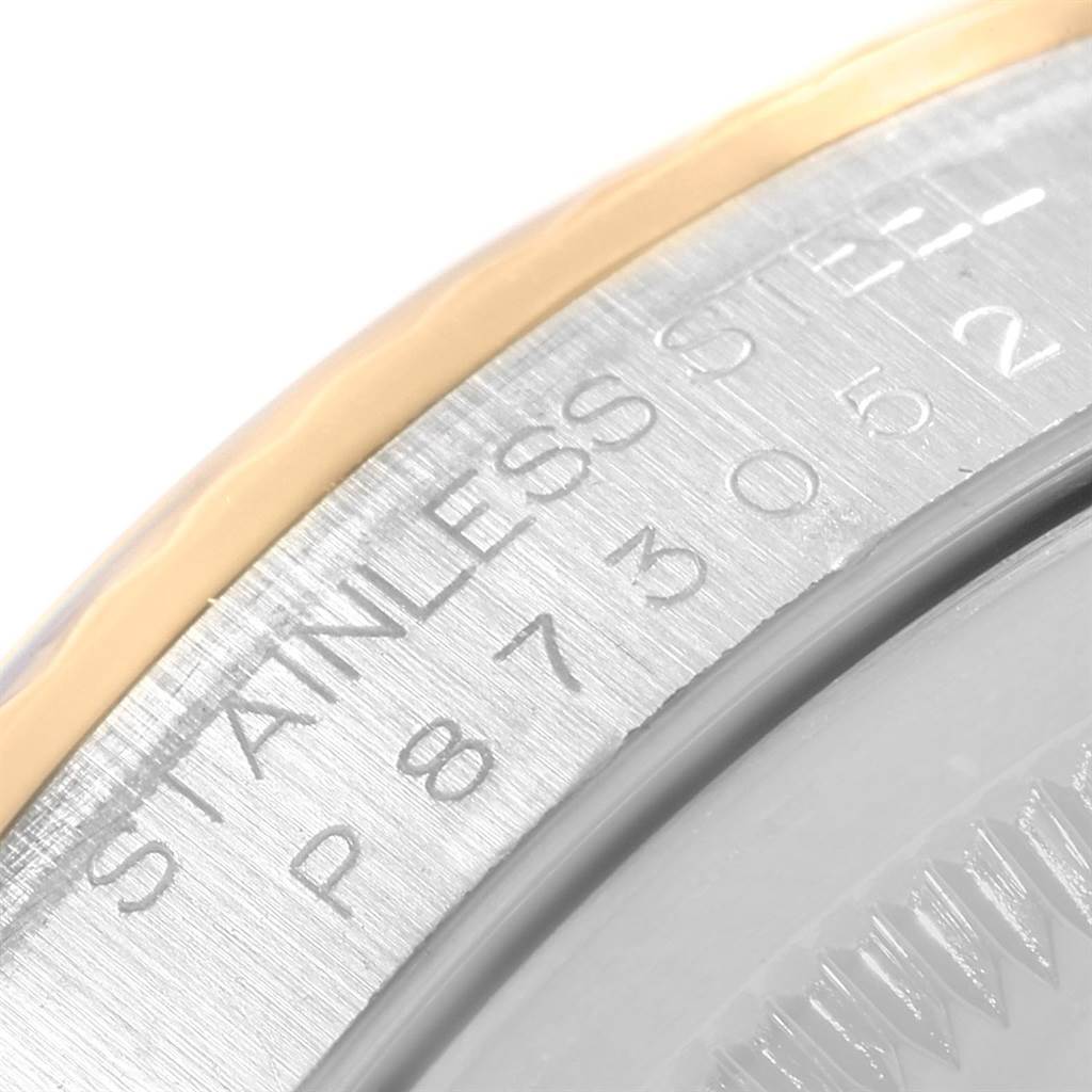 The image shows a close-up of the case back edge of a Rolex Datejust 16233 Men's Steel and Gold (two tone) Blue Dial 16233 Men's Steel and Gold (two tone) Blue Dial, highlighting the stainless steel and part of the serial number.
