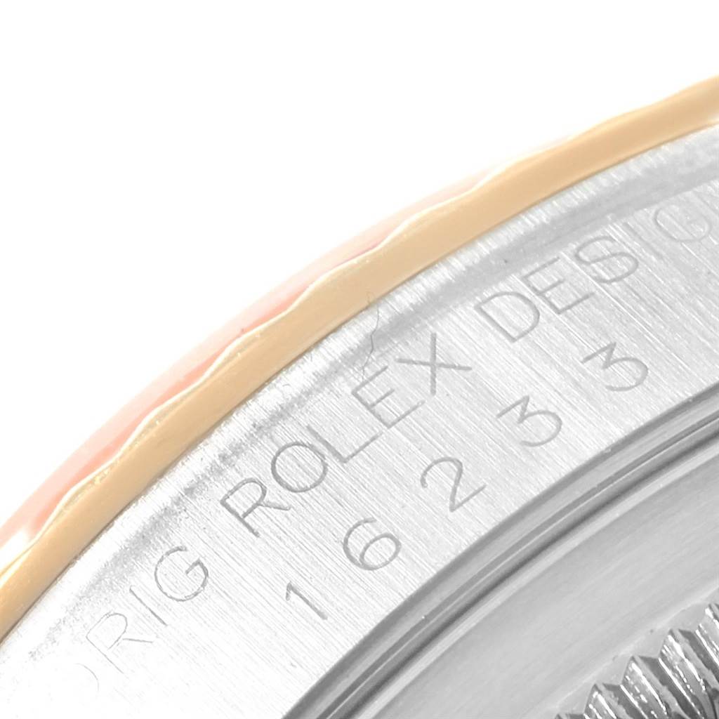 This image shows a close-up view of the bezel and engraved design details of the Rolex Datejust 16233 Men's Steel and Gold (two tone) Champagne Dial 16233 Men's Steel and Gold (two tone) Champagne Dial watch.