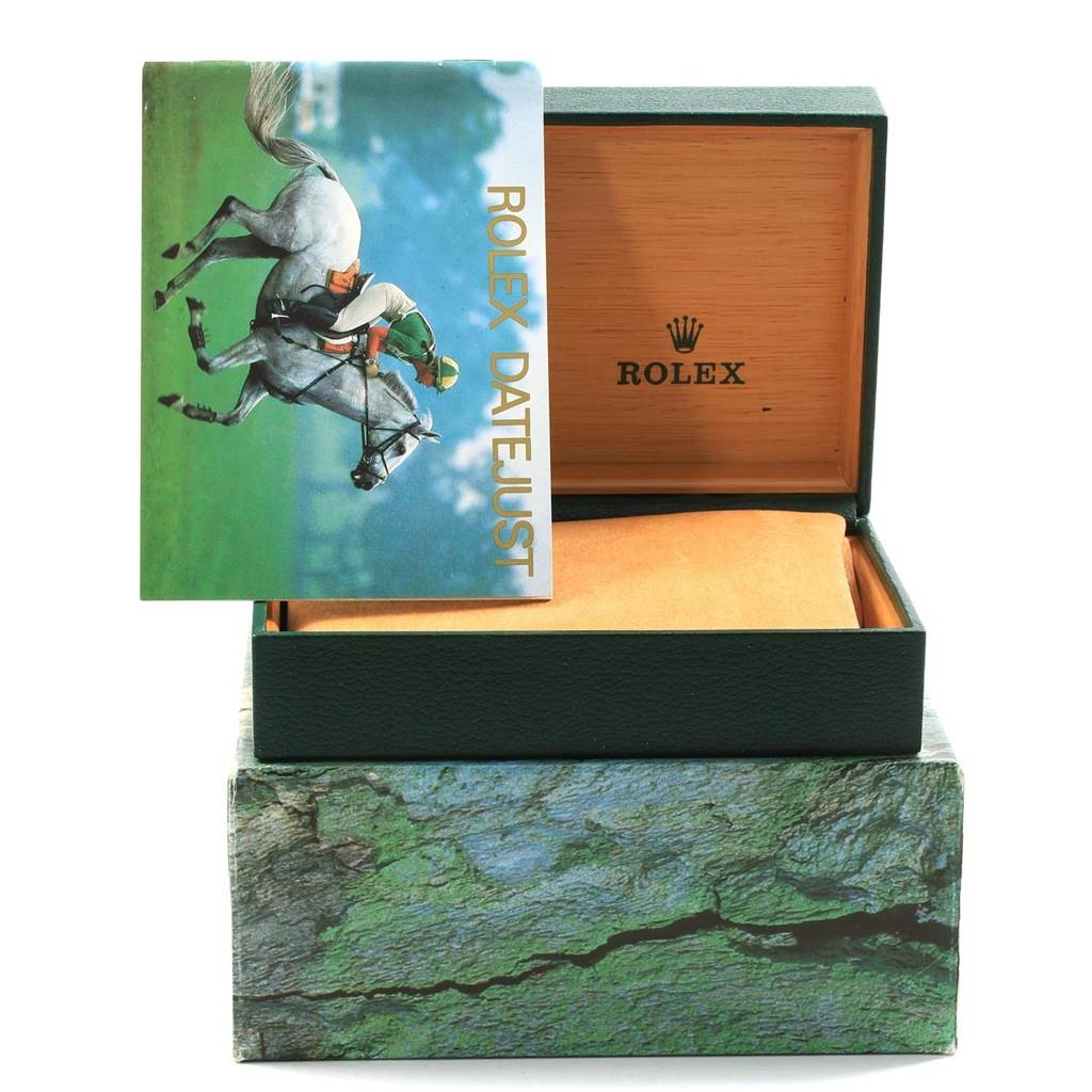 The image shows an open Rolex Datejust 16220 Men's Stainless Steel Silver Dial 16220 Men's Stainless Steel Silver Dial watch box with a booklet placed to the side of the lid.