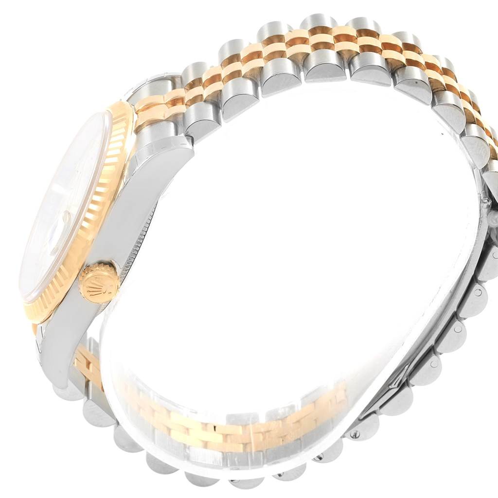 The image shows a side view of the Rolex Datejust 116233 Men's Steel and Gold (two tone) Mother of Pearl Dial 116233 Men's Steel and Gold (two tone) Mother of Pearl Dial watch, highlighting its crown, case, and two-tone bracelet.