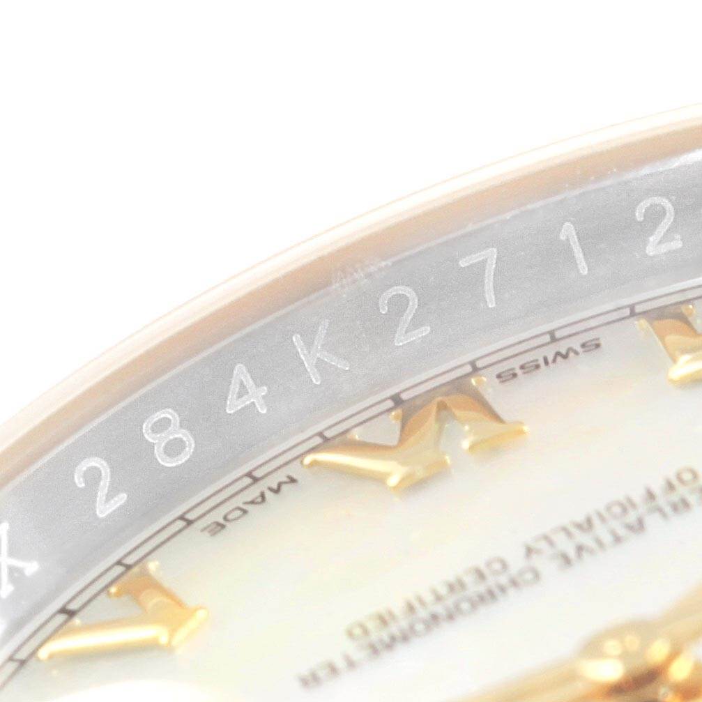 The image shows a close-up of the dial and chapter ring of a Rolex Datejust 116233 Men's Steel and Gold (two tone) Mother of Pearl Dial 116233 Men's Steel and Gold (two tone) Mother of Pearl Dial model, displaying part of the serial number and some hour markers.