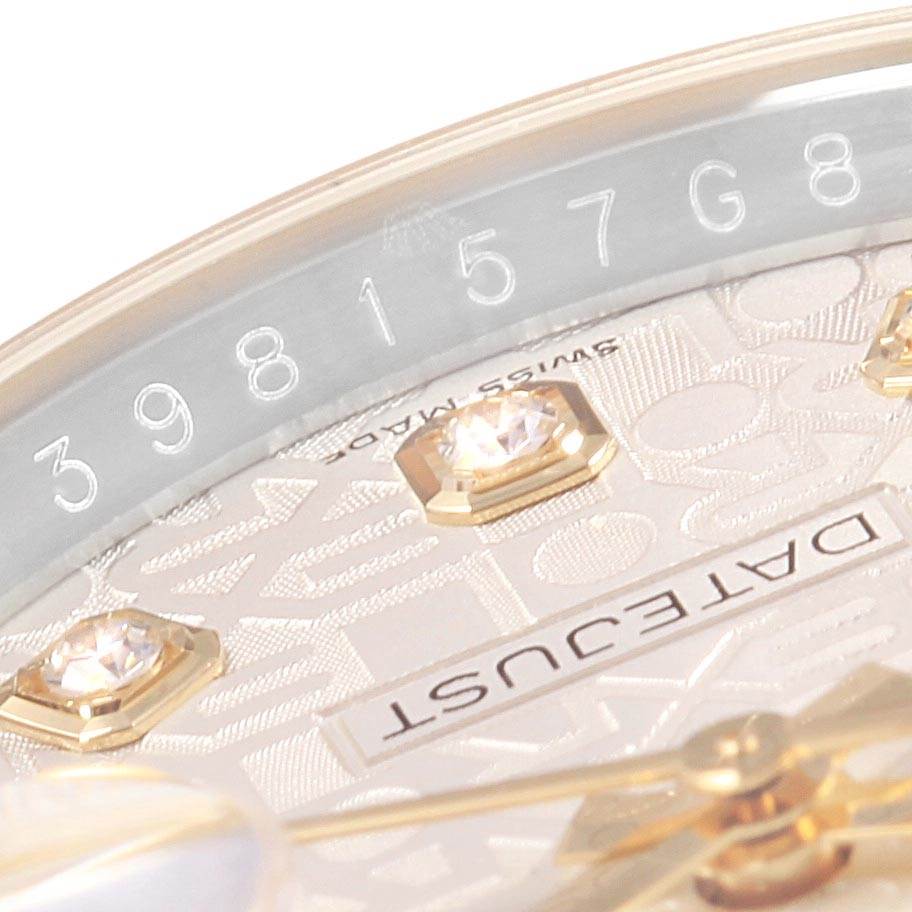 The image shows a close-up of the Rolex Datejust 116233 Men's Stainless Steel Silver Dial 116233 Men's Stainless Steel Silver Dial watch's dial and part of the bezel with serial number engraving.