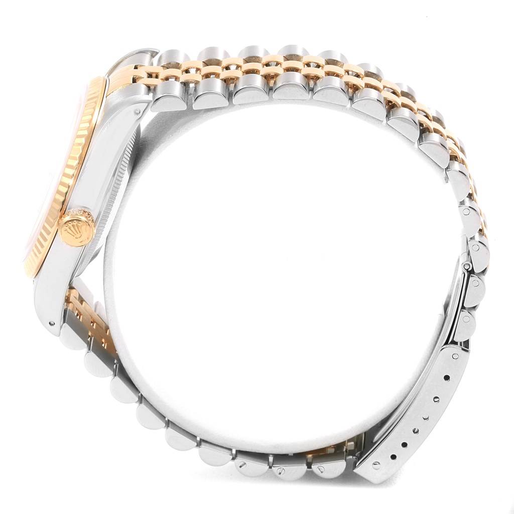 The image shows a side view of a Rolex Datejust 16233 Men
s Steel and Gold (two tone) White Dial 16233 Men
s Steel and Gold (two tone) White Dial watch, highlighting its crown, bezel, and two-tone bracelet.