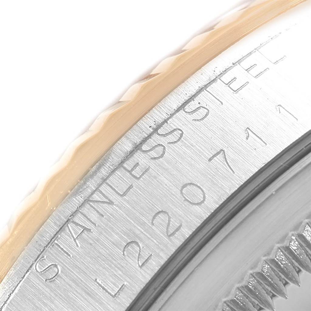 The image shows a close-up view of the side of the bezel and the stainless steel engravings on a Rolex Datejust 16233 Men
s Steel and Gold (two tone) White Dial 16233 Men
s Steel and Gold (two tone) White Dial model watch.