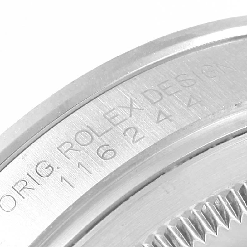 This image shows a close-up of the engraved edge and part of the case back of a Rolex Datejust 116244 Men's Stainless Steel Mother of Pearl Dial 116244 Men's Stainless Steel Mother of Pearl Dial watch.