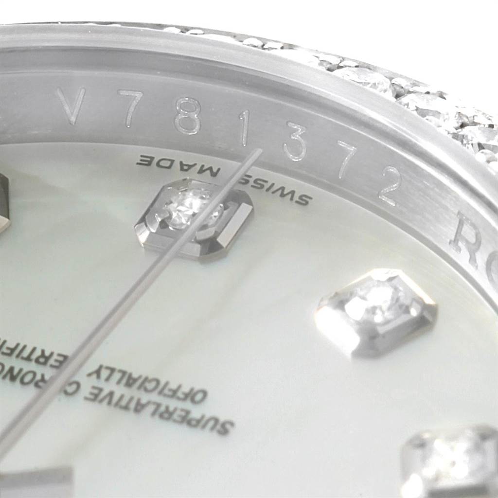 This close-up of a Rolex Datejust 116244 Men's Stainless Steel Mother of Pearl Dial 116244 Men's Stainless Steel Mother of Pearl Dial watch shows parts of the dial, markers, and part of the serial number.