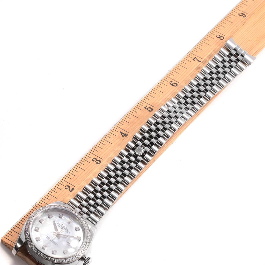 The image shows a Rolex Datejust 116244 Men's Stainless Steel Mother of Pearl Dial 116244 Men's Stainless Steel Mother of Pearl Dial watch placed next to a ruler to measure the band length.