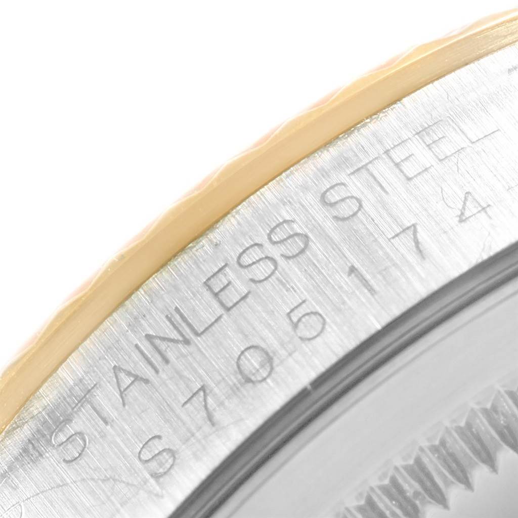 The image shows a close-up of the bezel and edge of the case back of a Rolex Datejust 16233 Men's Steel and Gold (two tone) Champagne Dial 16233 Men's Steel and Gold (two tone) Champagne Dial watch.