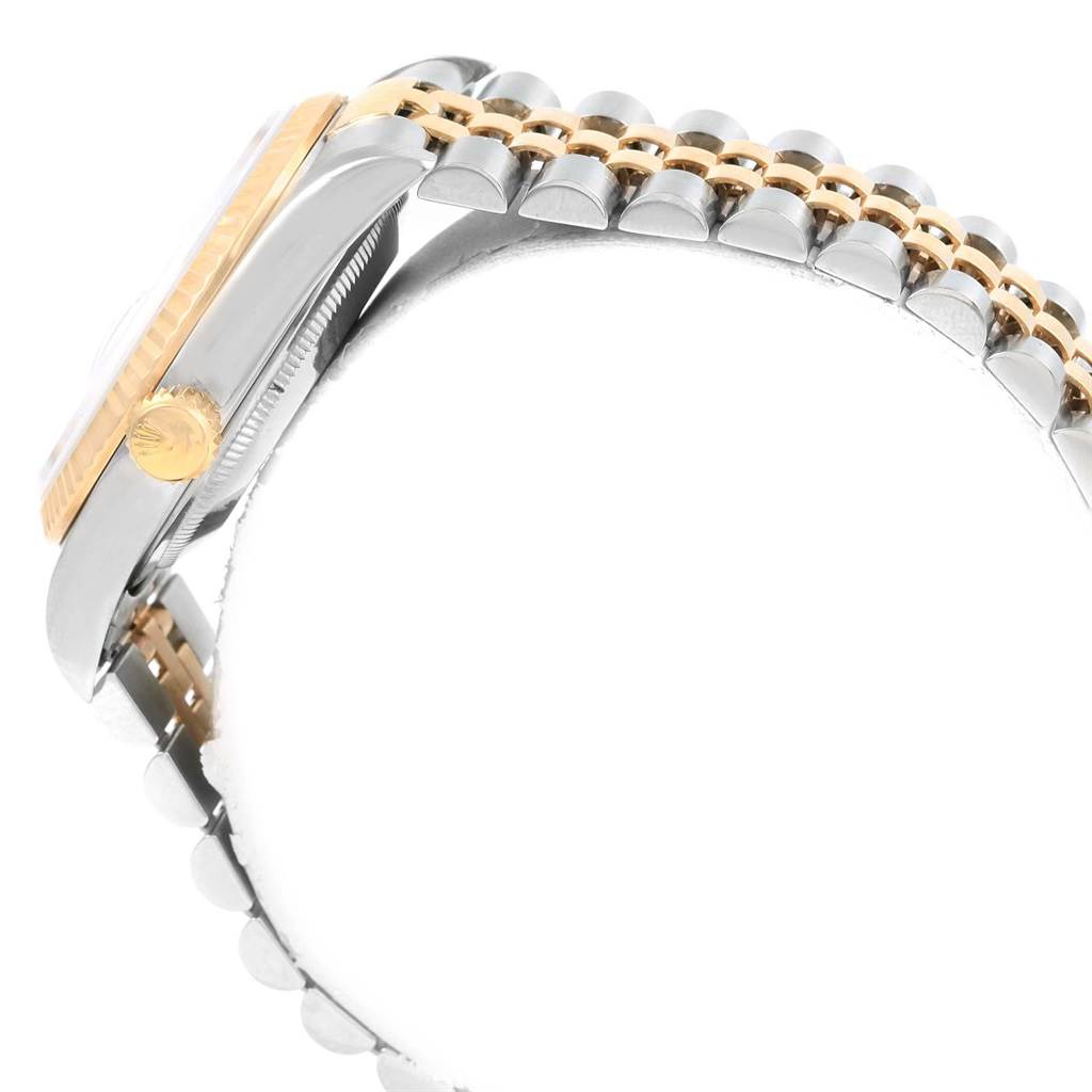 The image shows a side view of the Rolex Datejust 16233 Men's Steel and Gold (two tone) Champagne Dial 16233 Men's Steel and Gold (two tone) Champagne Dial watch, highlighting the crown, fluted bezel, and part of the bracelet.