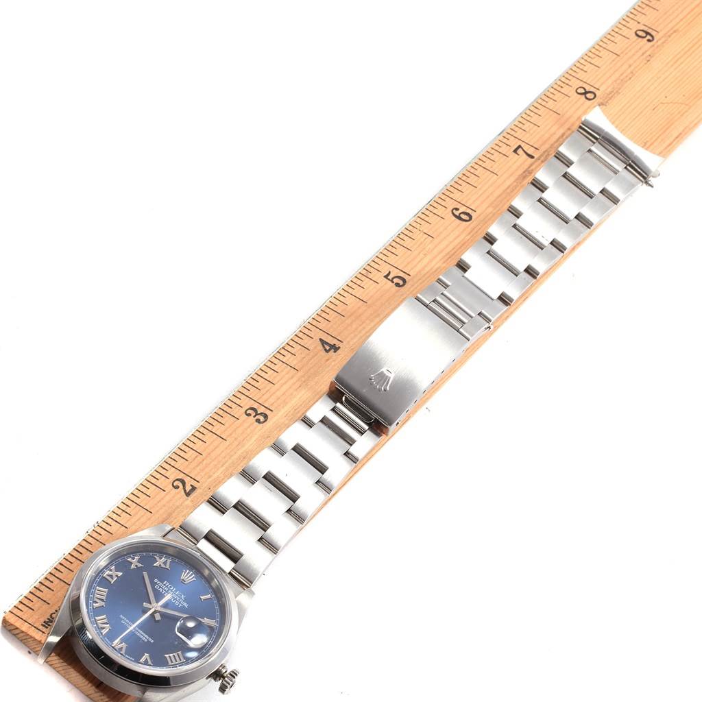 The image shows a Rolex Datejust 16200 Men's Stainless Steel Blue Dial 16200 Men's Stainless Steel Blue Dial watch lying flat with a ruler measuring its metal bracelet.