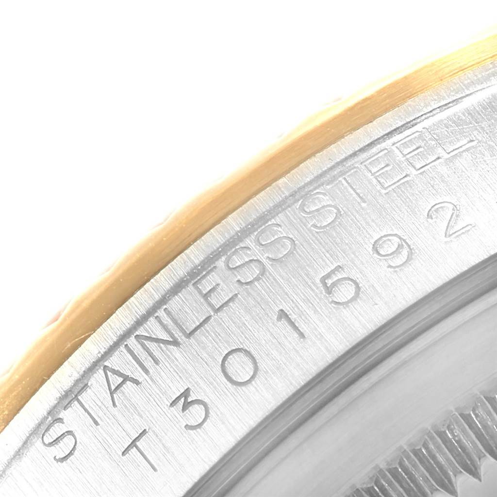 This close-up image shows the engraved serial number and "STAINLESS STEEL" inscription on the case side of a Rolex Datejust 16233 Men's Steel and Gold (two tone) Champagne Dial 16233 Men's Steel and Gold (two tone) Champagne Dial watch.