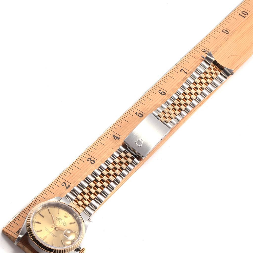 The image shows a Rolex Datejust 16233 Men's Steel and Gold (two tone) Champagne Dial 16233 Men's Steel and Gold (two tone) Champagne Dial watch angled flat, featuring its dial and bracelet, measured next to a wooden ruler.