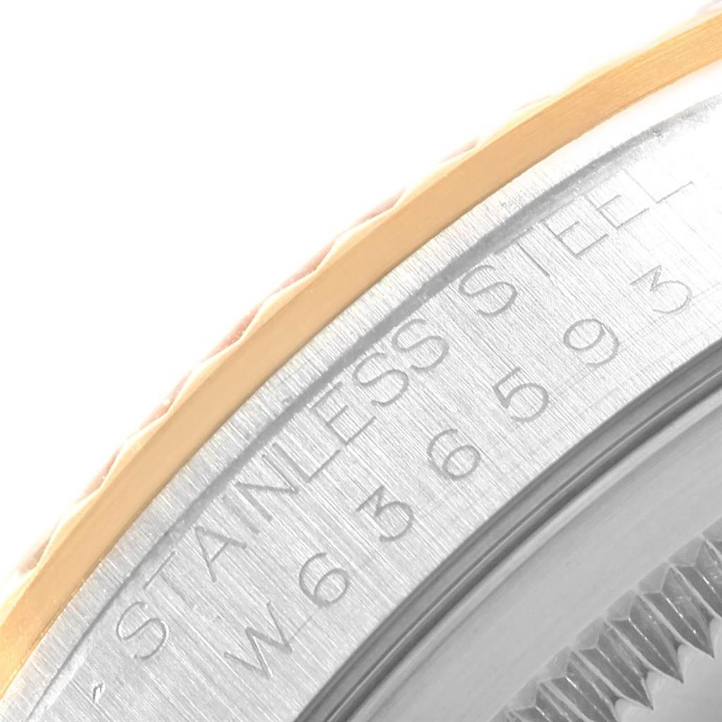 This close-up image of a Rolex Datejust 16233 Men's Steel and Gold (two tone) Champagne Dial 16233 Men's Steel and Gold (two tone) Champagne Dial watch shows the engraved bezel edge and part of the side case with the text "STAINLESS STEEL."