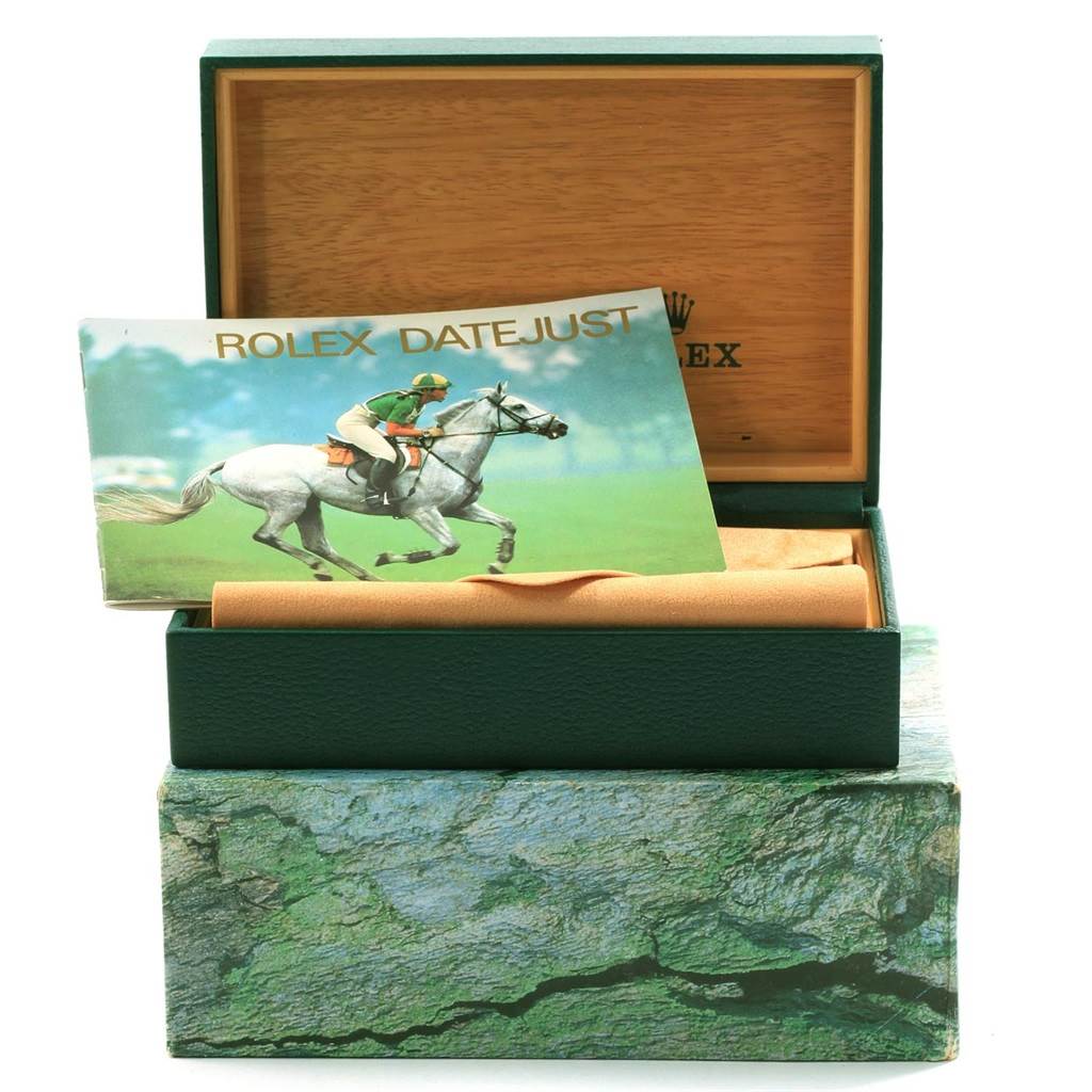 The image shows a Rolex Datejust 16233 Men's Steel and Gold (two tone) Champagne Dial 16233 Men's Steel and Gold (two tone) Champagne Dial box and a booklet in an open position, with no view of the watch itself.