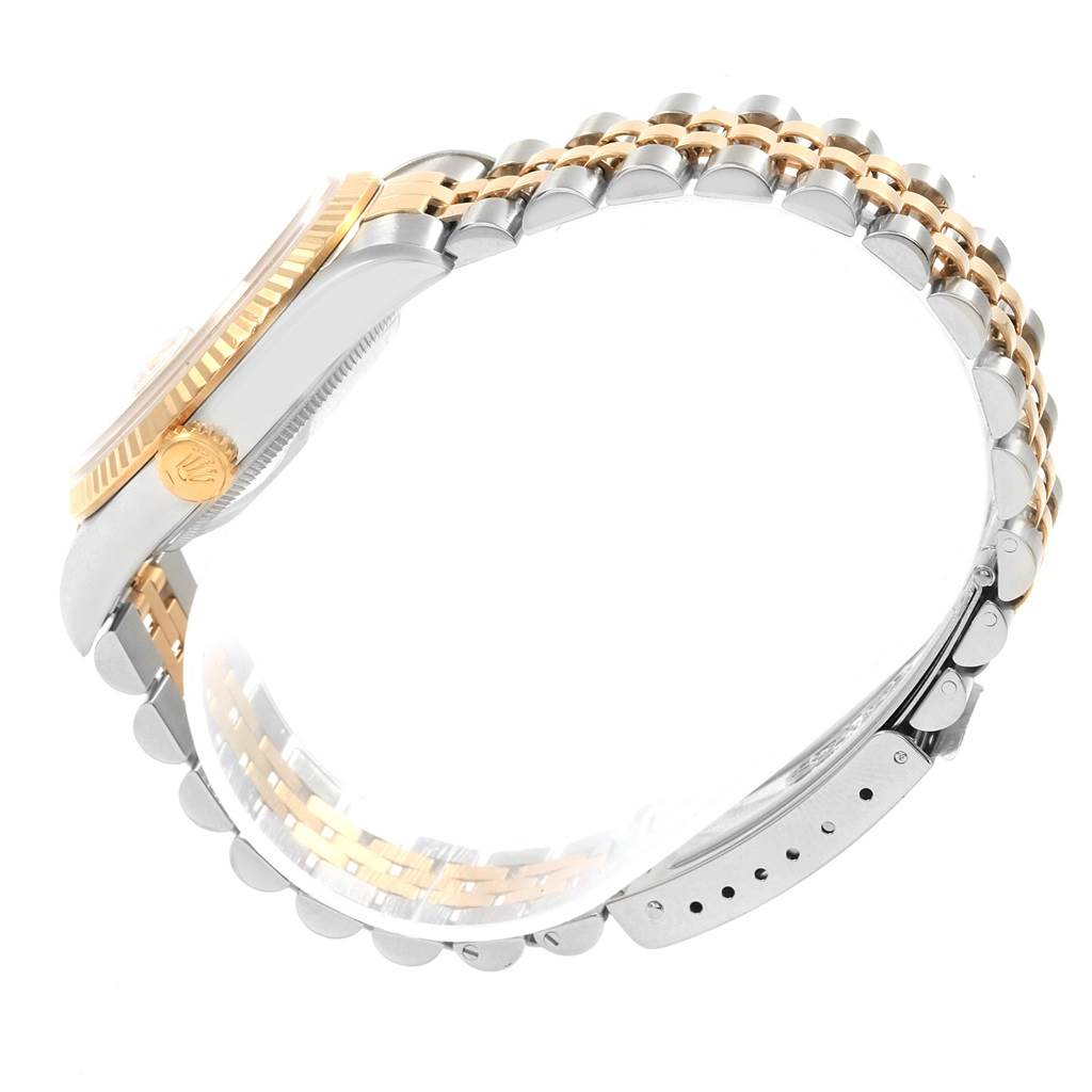 The image shows a side view of the Rolex Datejust 16233 Men's Steel and Gold (two tone) Champagne Dial 16233 Men's Steel and Gold (two tone) Champagne Dial watch, highlighting the gold and silver bracelet and the watch's crown.