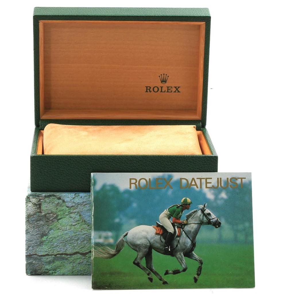 The image shows the box and manual of a Rolex Datejust 16220 Men's Stainless Steel Blue Dial 16220 Men's Stainless Steel Blue Dial watch, with the box open and the manual leaning against it.