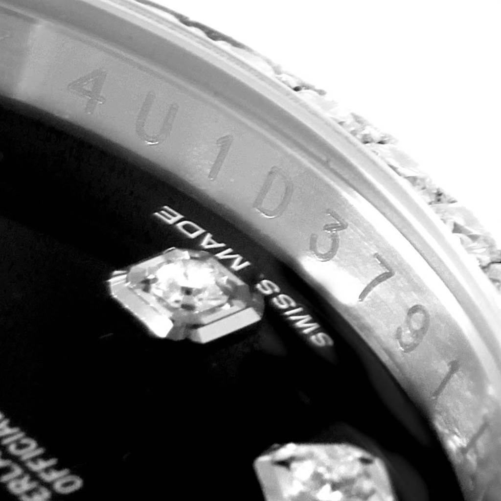 The image shows a close-up of the serial number and part of the dial with diamond markers on a Rolex Datejust 116244 Men's Stainless Steel Black Dial 116244 Men's Stainless Steel Black Dial model watch.