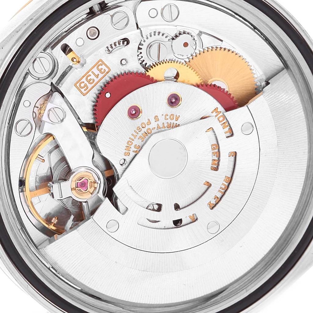 This image shows a close-up of the movement mechanisms inside the Rolex Datejust 16233 Men's Steel and Gold (two tone) Champagne Dial 16233 Men's Steel and Gold (two tone) Champagne Dial watch, highlighting gears and intricate parts.