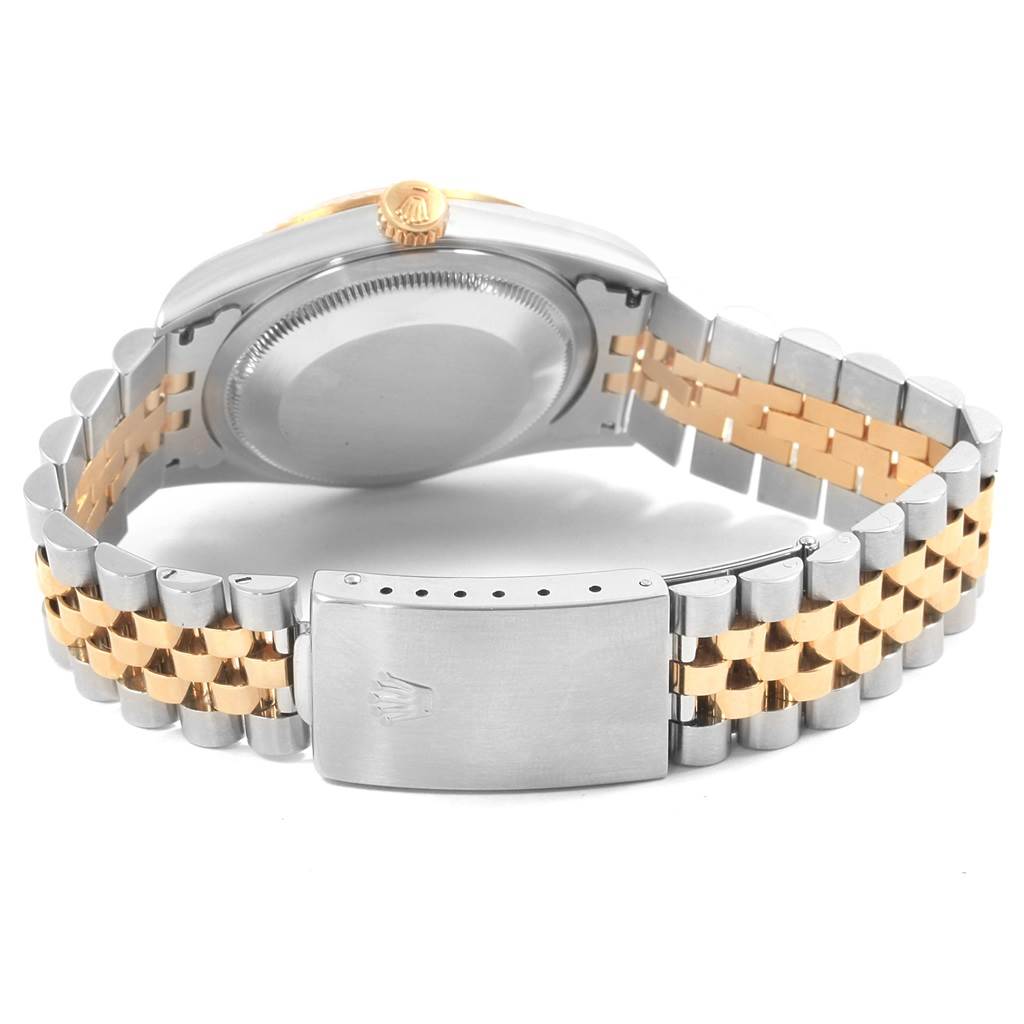 The image displays the back of a Rolex Datejust 16233 Men's Steel and Gold (two tone) Champagne Dial 16233 Men's Steel and Gold (two tone) Champagne Dial watch, highlighting its case back, crown, and two-tone bracelet with the clasp.