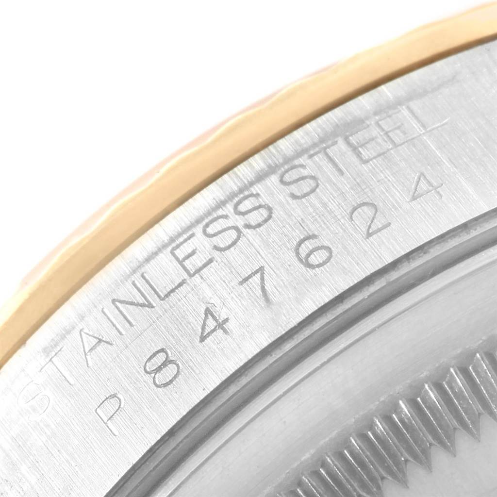 This close-up image focuses on the serial number and part of the stainless steel case back of a Rolex Datejust 16233 Men's Steel and Gold (two tone) Grey Dial 16233 Men's Steel and Gold (two tone) Grey Dial watch.