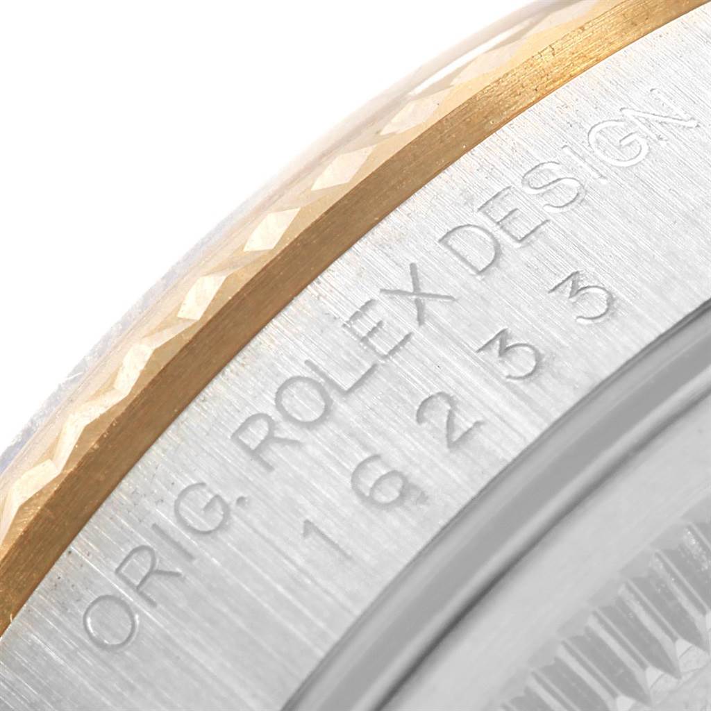 This close-up image shows part of the bezel and case side of the Rolex Datejust 16233 Men's Steel and Gold (two tone) Grey Dial 16233 Men's Steel and Gold (two tone) Grey Dial watch.