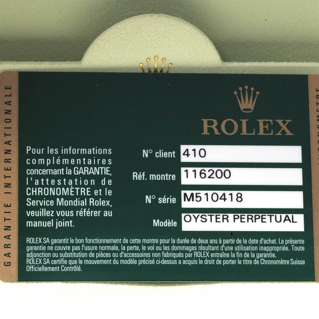 A Rolex Datejust 116200 Men's Stainless Steel Black Dial 116200 Men's Stainless Steel Black Dial warranty card in close-up, showing serial number, model number, and other details clearly.