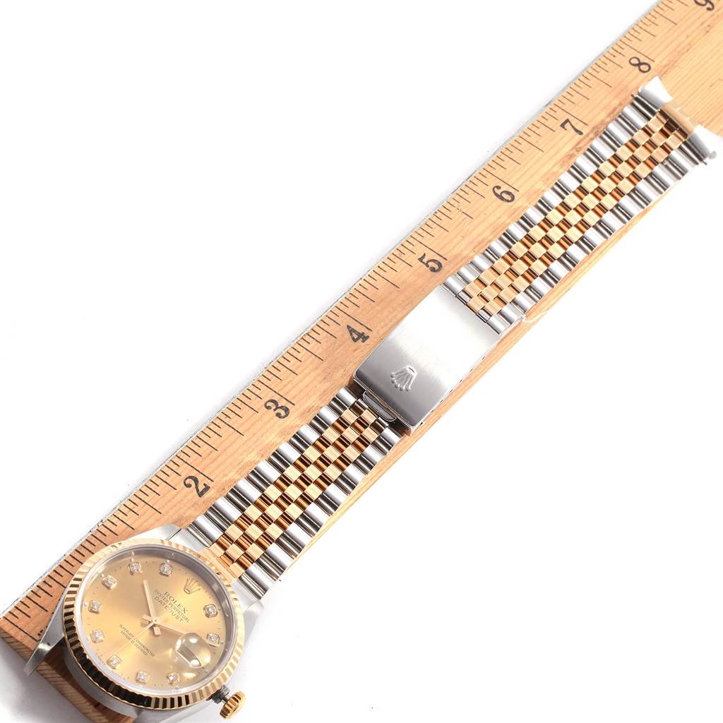 The image shows a Rolex Datejust 16233 Men's Steel and Gold (two tone) Champagne Dial 16233 Men's Steel and Gold (two tone) Champagne Dial watch laid flat, highlighting the face, bezel, crown, and the full length of the bracelet next to a ruler.