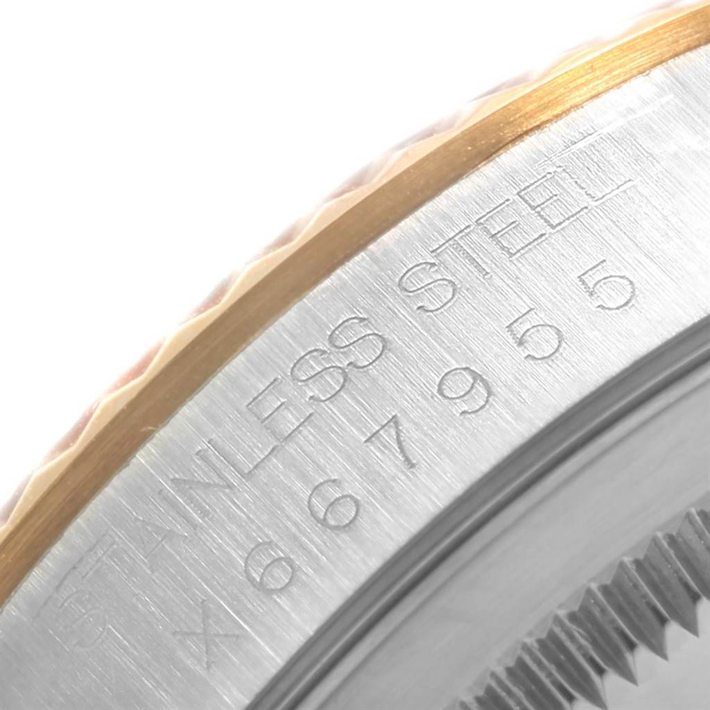 This is a close-up of the side of a Rolex Datejust 16233 Men's Steel and Gold (two tone) Blue Dial 16233 Men's Steel and Gold (two tone) Blue Dial watch, showcasing the stainless steel and part of the fluted bezel.
