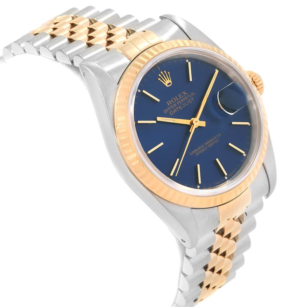 The image shows a Rolex Datejust 16233 Men's Steel and Gold (two tone) Blue Dial 16233 Men's Steel and Gold (two tone) Blue Dial watch angled to display the dial, bezel, crown, and part of the bracelet.