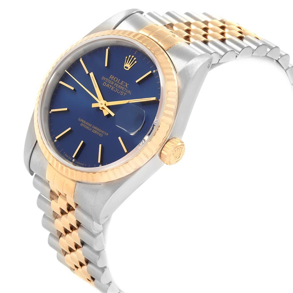 This Rolex Datejust 16233 Men's Steel and Gold (two tone) Blue Dial 16233 Men's Steel and Gold (two tone) Blue Dial watch is shown at a slight angle, highlighting its blue dial, fluted bezel, and two-tone bracelet.