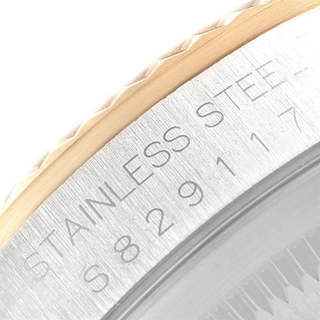 This close-up image shows the engraved bezel and serial number of a Rolex Datejust 16233 Men's Steel and Gold (two tone) Champagne Dial 16233 Men's Steel and Gold (two tone) Champagne Dial watch.