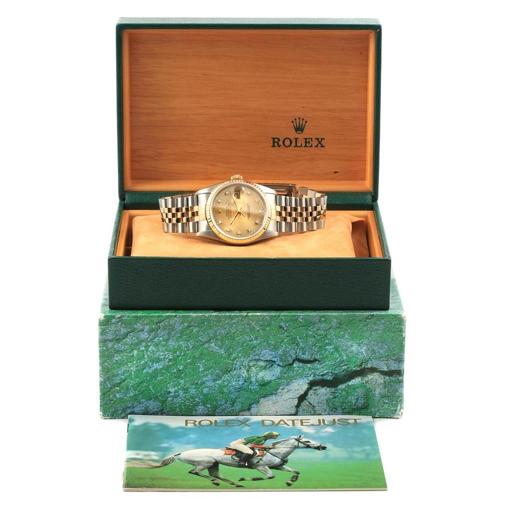 The image shows a Rolex Datejust 16233 Men's Steel and Gold (two tone) Champagne Dial 16233 Men's Steel and Gold (two tone) Champagne Dial watch from a front angle, displayed in an open box with a brochure in front.