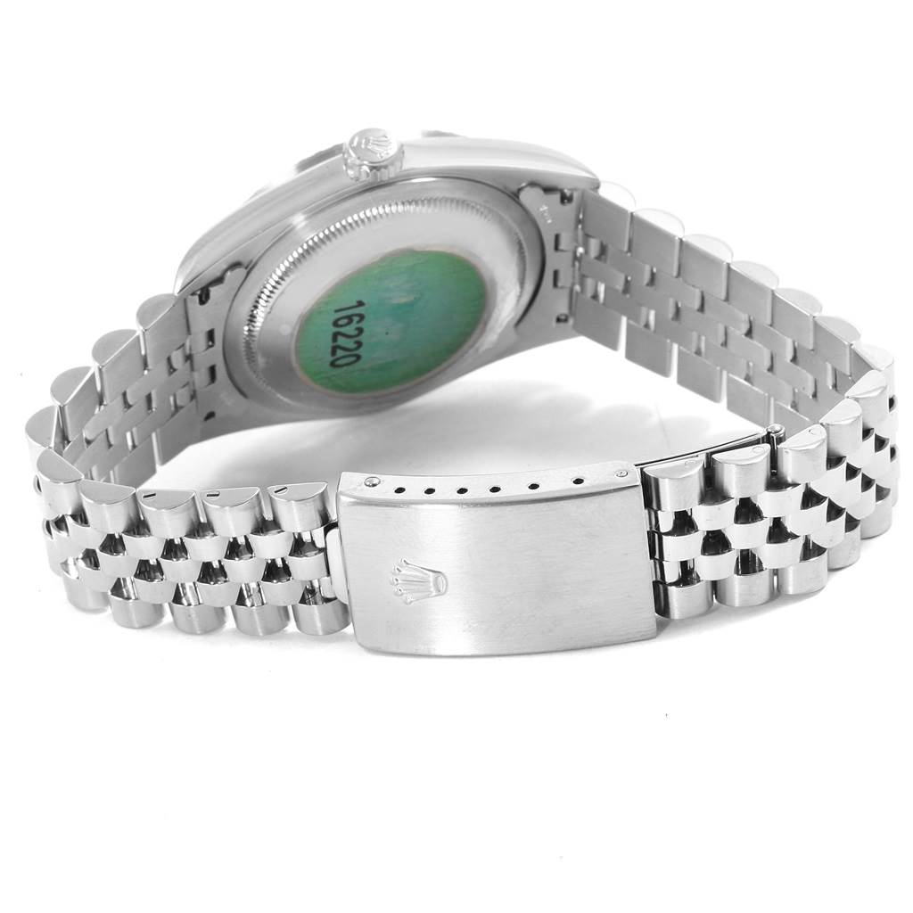 This Rolex Datejust 16220 Men's Stainless Steel Silver Dial 16220 Men's Stainless Steel Silver Dial watch is shown from the underside, displaying its case back and jubilee bracelet with the clasp open.