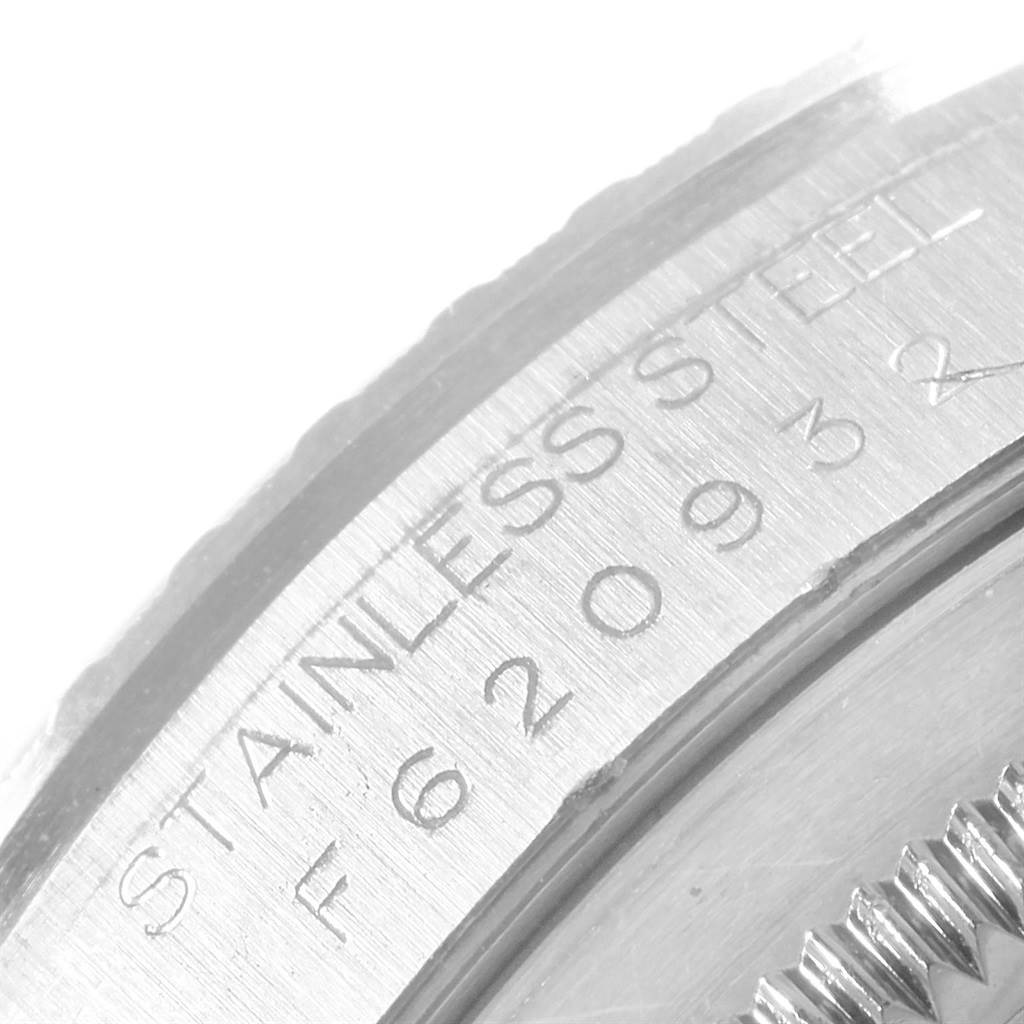 This close-up image shows the engraved stainless steel back case and part of the fluted bezel of a Rolex Datejust 16220 Men's Stainless Steel Silver Dial 16220 Men's Stainless Steel Silver Dial watch.