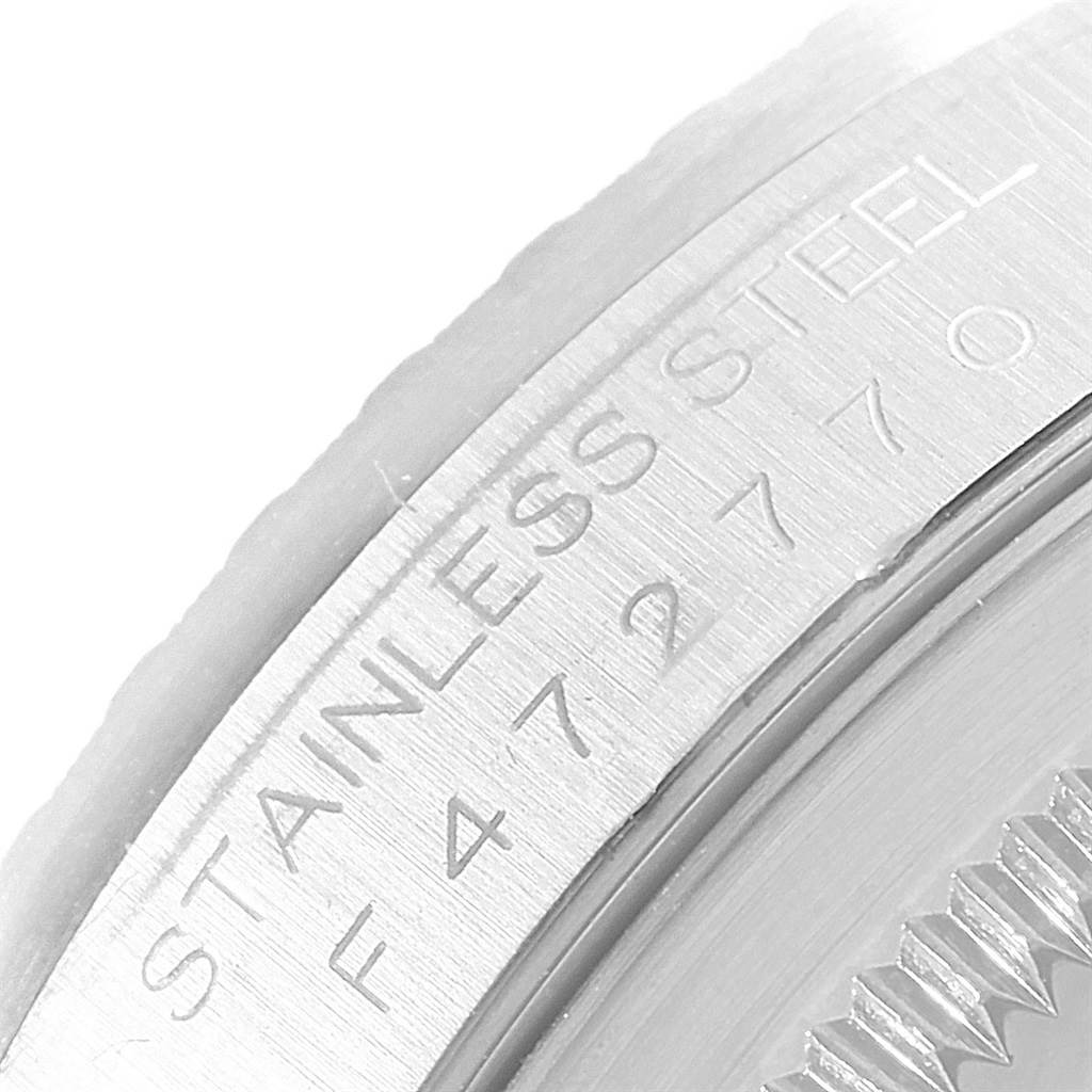 This image shows a close-up of the etched details on the side of a Rolex Datejust 16220 Men's Stainless Steel Silver Dial 16220 Men's Stainless Steel Silver Dial watch, specifically the "STAINLESS STEEL" engraving.