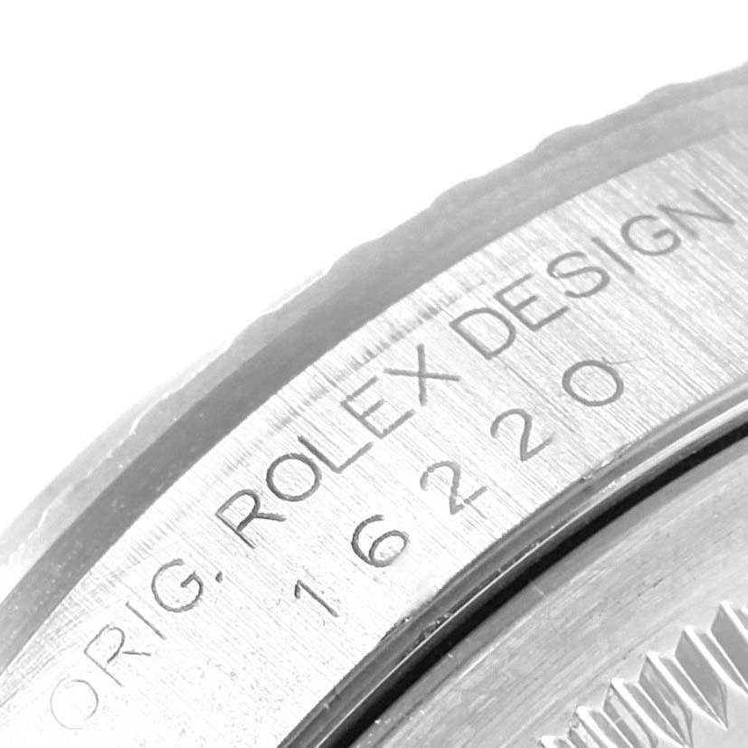 This close-up image shows the engraved bezel of the Rolex Datejust 16220 Men
s Stainless Steel Silver Dial 16220 Men
s Stainless Steel Silver Dial model, emphasizing the serial number.