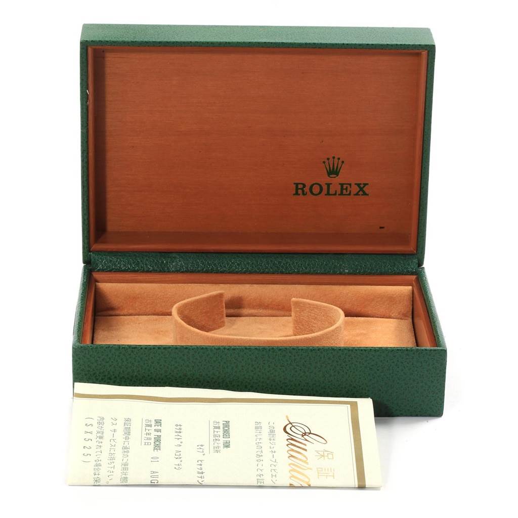 The image shows the opened green Rolex Datejust 16220 Men
s Stainless Steel Silver Dial 16220 Men
s Stainless Steel Silver Dial watch box with a cushion and warranty card.