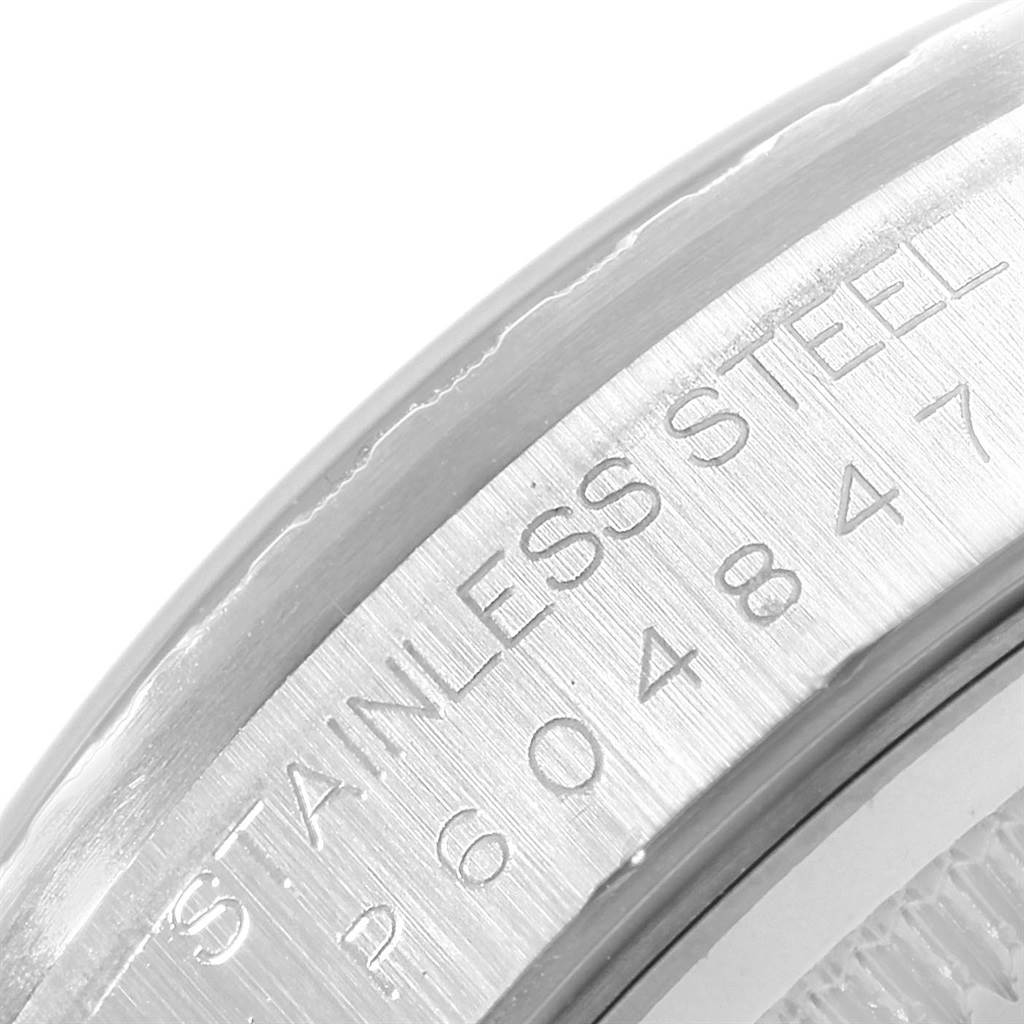 This close-up image shows the stainless steel case back of a Rolex Datejust 16220 Men
s Stainless Steel Silver Dial 16220 Men
s Stainless Steel Silver Dial watch, featuring engraved serial numbers.