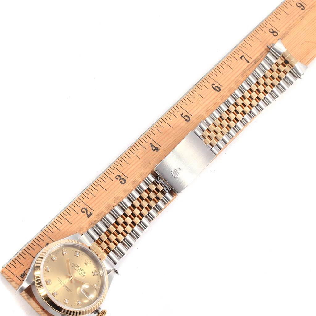 The image shows a Rolex Datejust 16233 Men's Steel and Gold (two tone) Champagne Dial 16233 Men's Steel and Gold (two tone) Champagne Dial watch laid flat next to a ruler, displaying the face and full bracelet.
