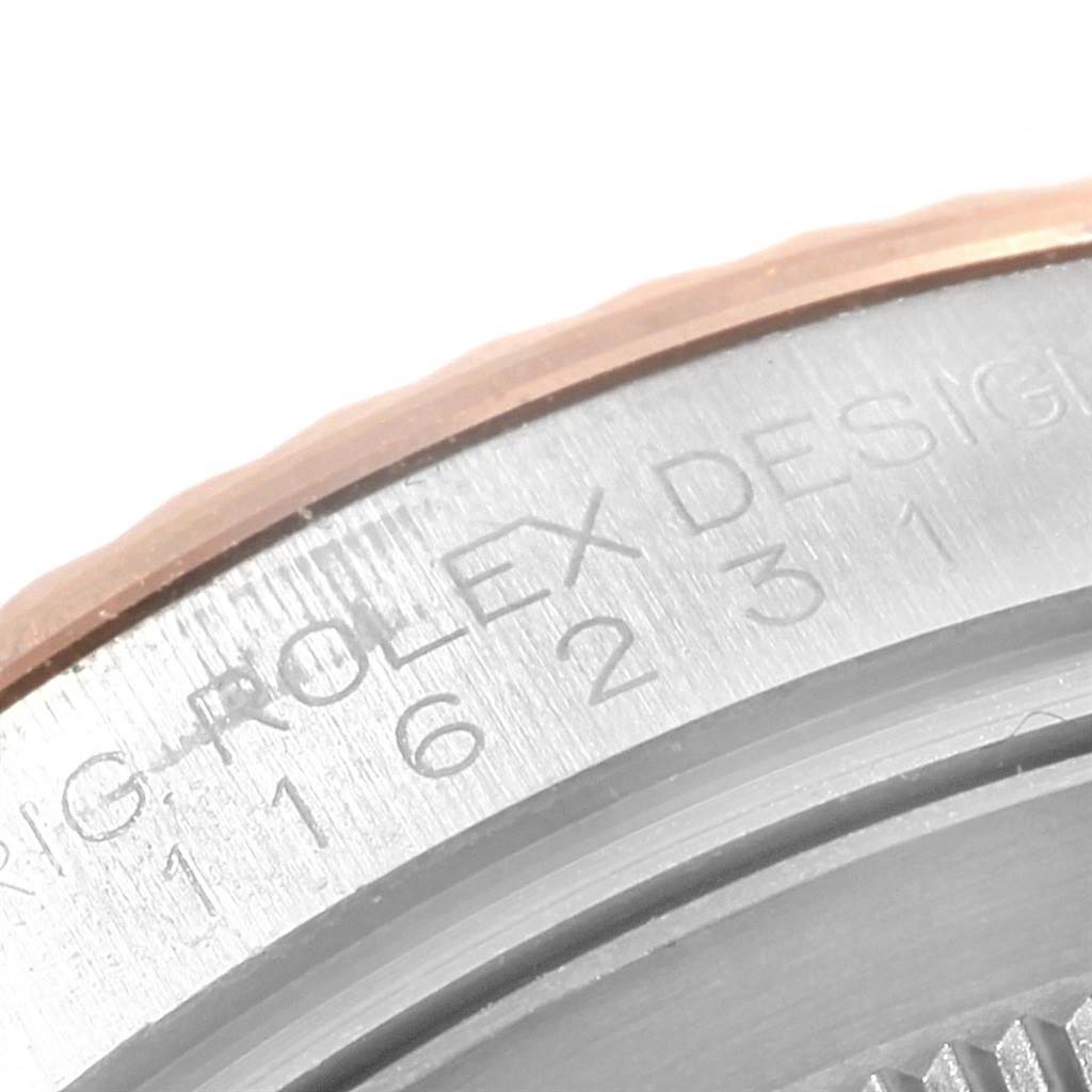 The image shows a close-up of the side engraving and bezel edge of a Rolex Datejust 116231 Men's Steel and Gold (two tone) Black Dial 116231 Men's Steel and Gold (two tone) Black Dial watch.