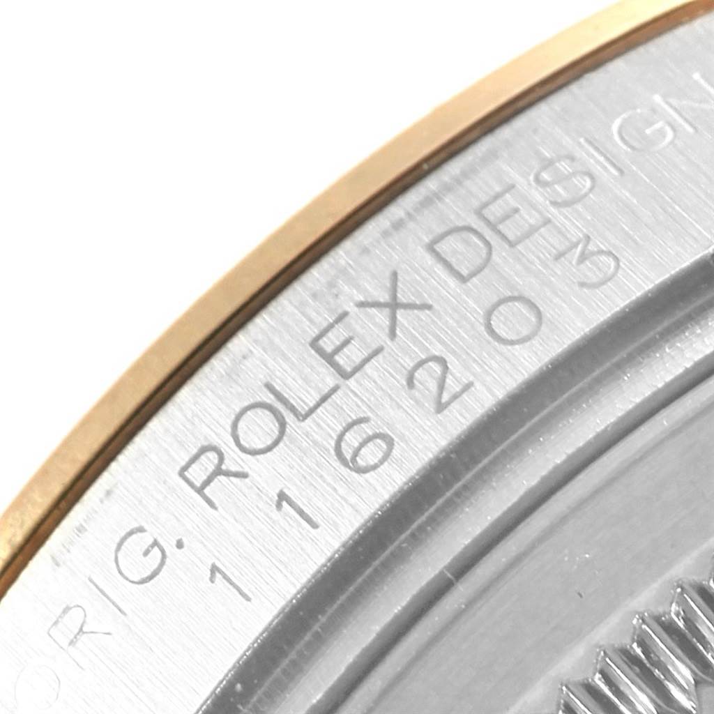 This image shows a close-up of the casing edge on a Rolex Datejust 116203 Men's Stainless Steel Grey Dial 116203 Men's Stainless Steel Grey Dial watch, highlighting the serial number and "ROLEX DESIGN" engraving.