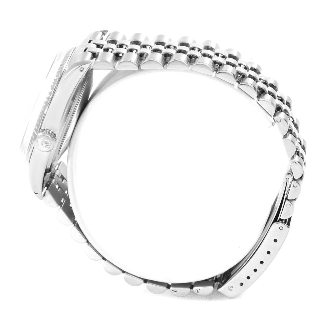 The image shows a side view of the Rolex Datejust 16014 Men's Stainless Steel Silver Dial 16014 Men's Stainless Steel Silver Dial watch highlighting the crown, case, and bracelet.