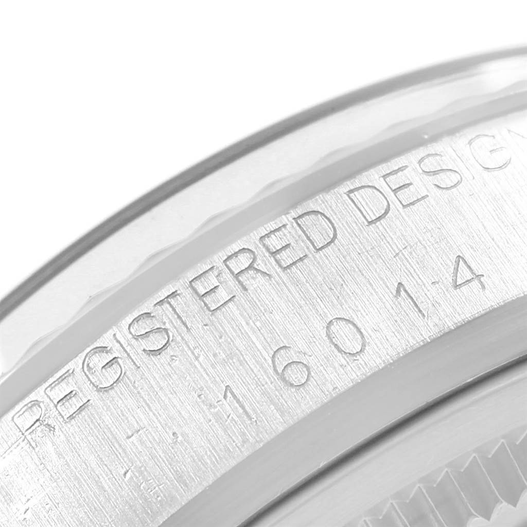 The image shows a close-up of the engravings on the bezel of a Rolex Datejust 16014 Men's Stainless Steel Silver Dial 16014 Men's Stainless Steel Silver Dial watch.