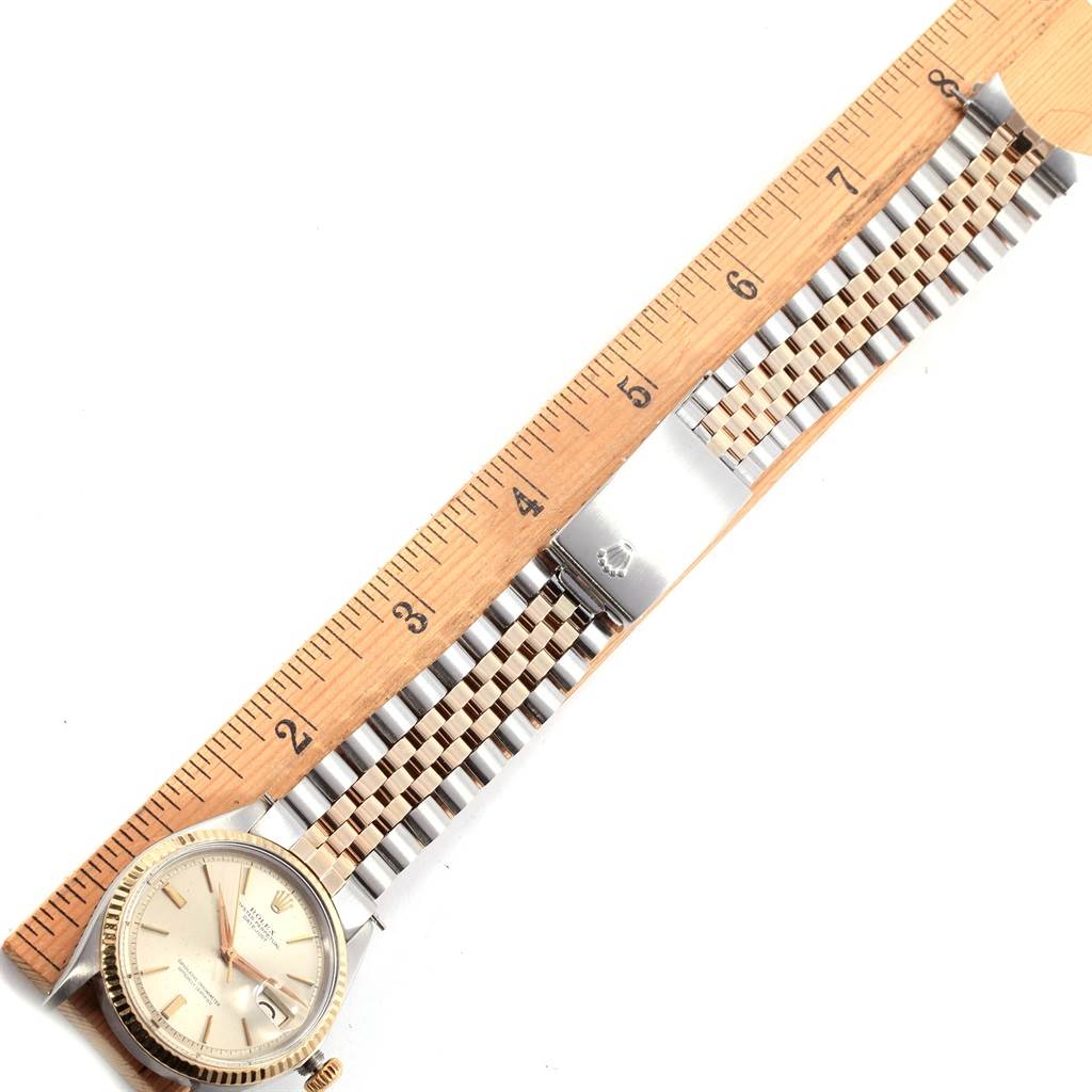 This image shows a Vintage Collection Rolex watch lying flat, with a ruler illustrating the length of its band and dial.