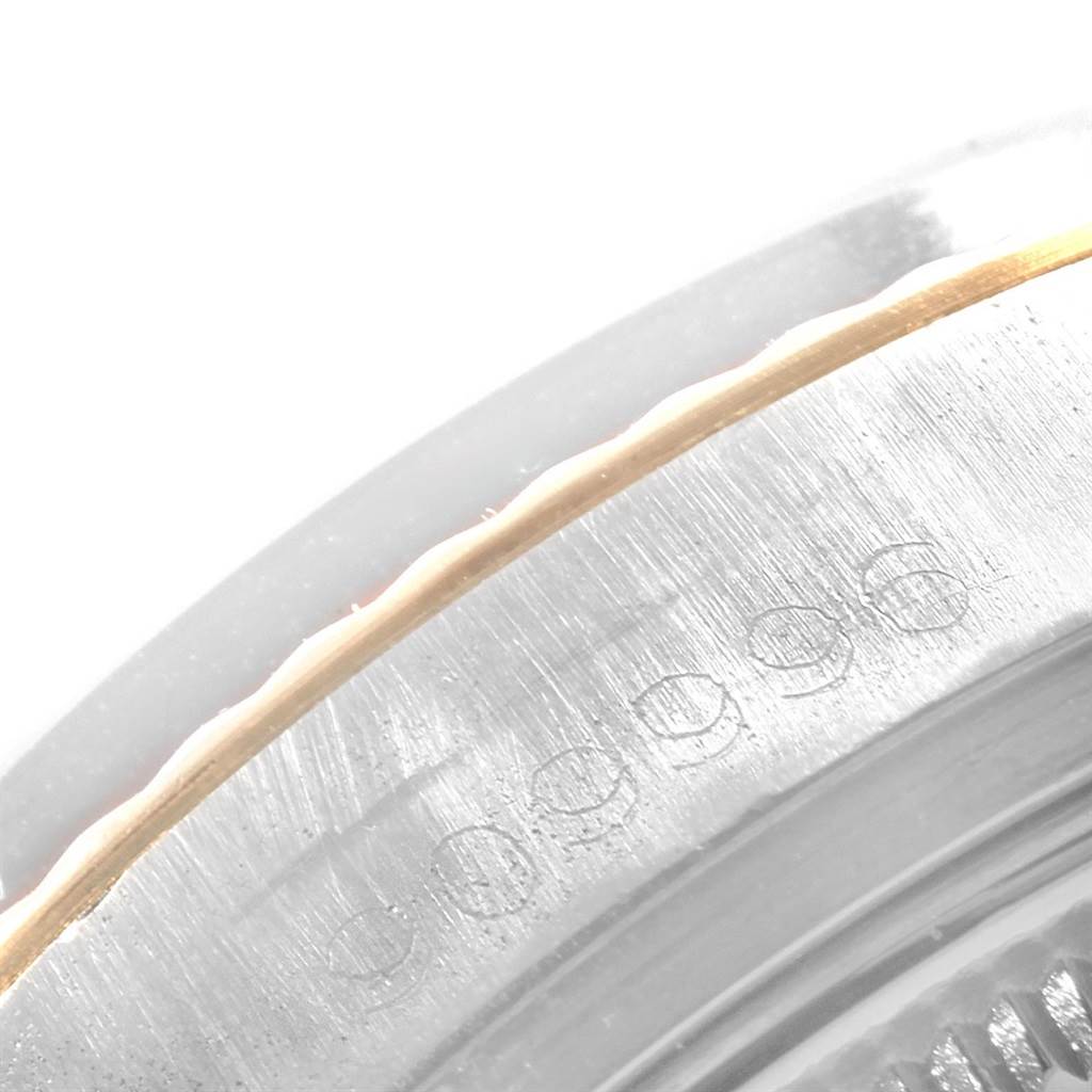 This image shows a close-up of the serial number engraving on the bezel of a Rolex Vintage Collection 1601 Men's Steel and Gold (two tone) Silver Dial 1601 Men's Steel and Gold (two tone) Silver Dial watch.