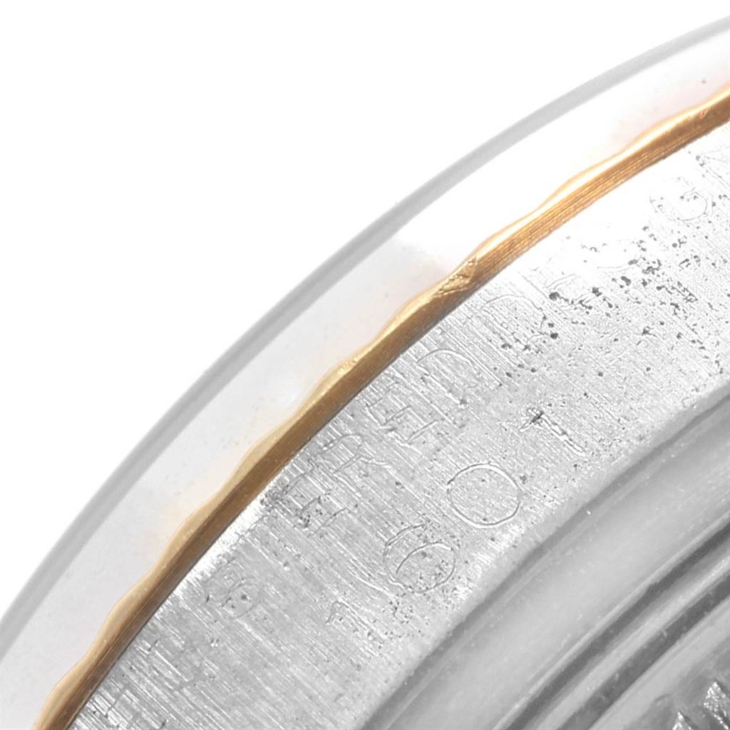 This image shows a close-up of the edge of a Rolex Vintage Collection 1601 Men's Steel and Gold (two tone) Silver Dial 1601 Men's Steel and Gold (two tone) Silver Dial watch case, highlighting the engraved markings and bezel.