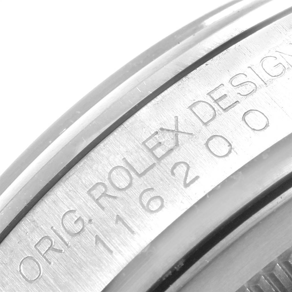 This close-up image shows the side engraving with the model number and "ORIG. ROLEX DESIGN" on a Rolex Datejust 116200 Men's Stainless Steel Silver Dial 116200 Men's Stainless Steel Silver Dial watch.